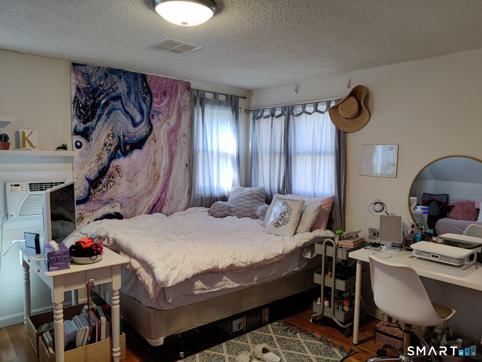 100 Loftus Circle Bridgeport, CT 06606 - Photo 7 of 16 a bedroom with a bed and a chandelier