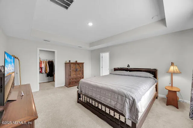 a bedroom with bed and walk in closet