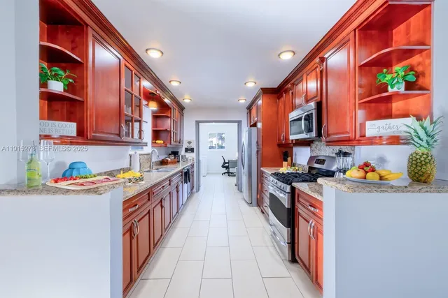 a kitchen with stainless steel appliances granite countertop lots of counter top space