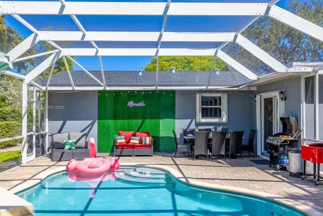 a view of yard with swimming pool and sitting area