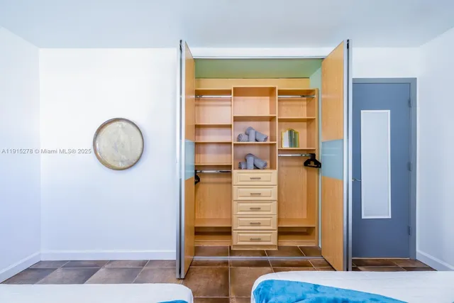 a bedroom with furniture and a window