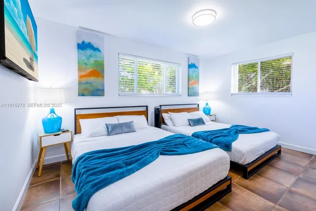 a bedroom with furniture and a wooden floor