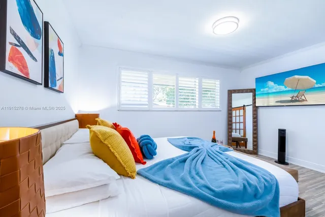 a bedroom with furniture and a potted plant