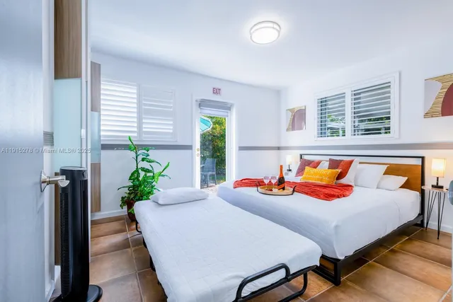 a bedroom with a bed and a potted plant