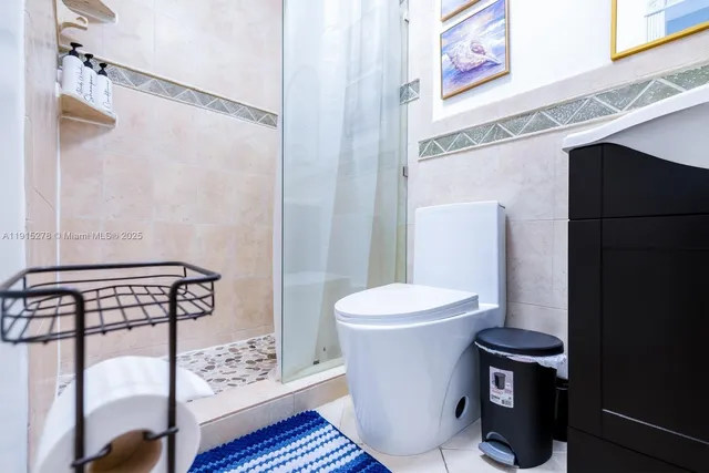 a living room with patio furniture and a floor to ceiling window