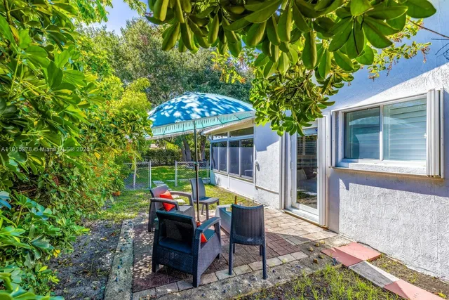 a view of a workspace with furniture and wooden floor