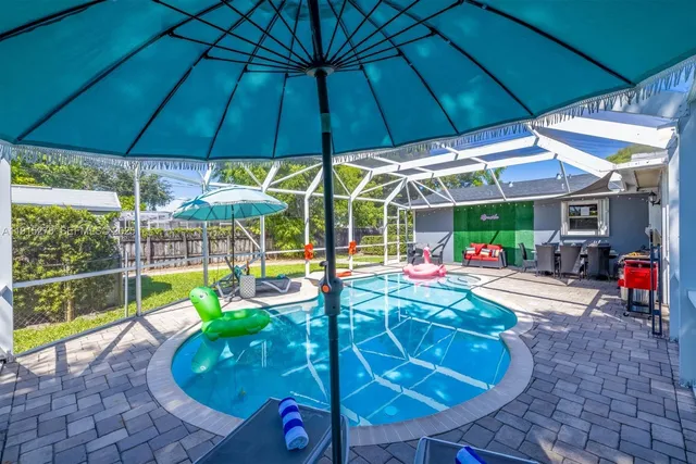 an aerial view of a house with a swimming pool