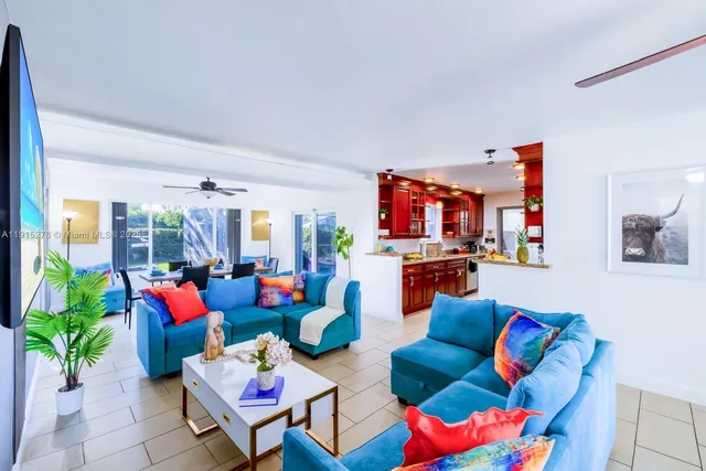 a living room with furniture a rug and a large window