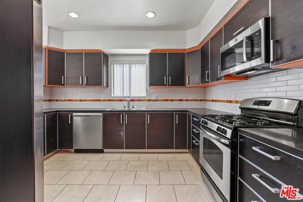 a kitchen with stainless steel appliances granite countertop a stove and a sink
