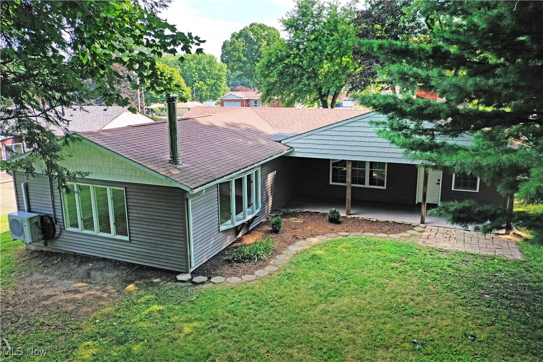 7655 Connelly Road Masury, OH 44438 - Photo 46 of 46 Rear view of property with a lawn, roof with shingles, and a patio area