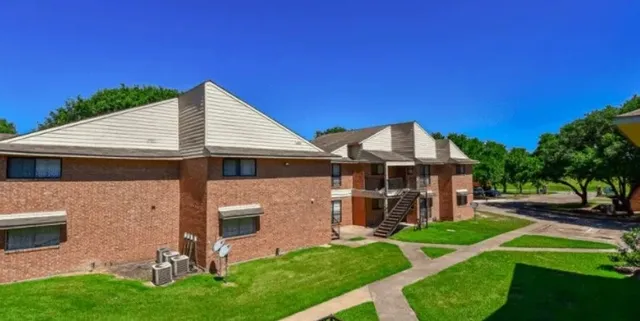 a front view of a house with a garden and plants
