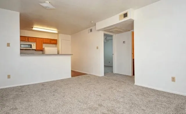 a view of a room with a hallway and a refrigerator