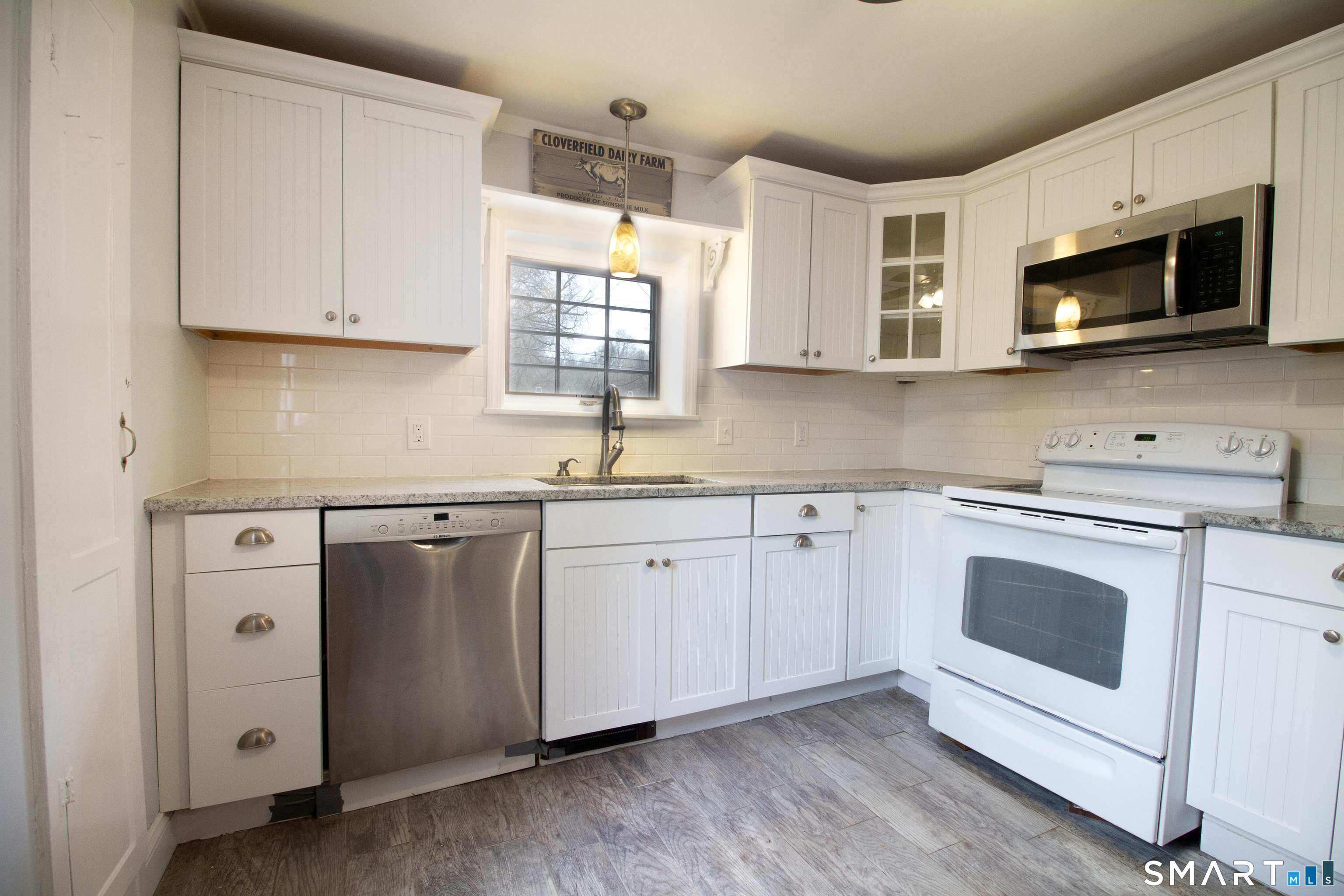 21 B Hoydens Hill Road Fairfield, CT 06824 - Photo 14 of 39 a kitchen with white cabinets stainless steel appliances and sink