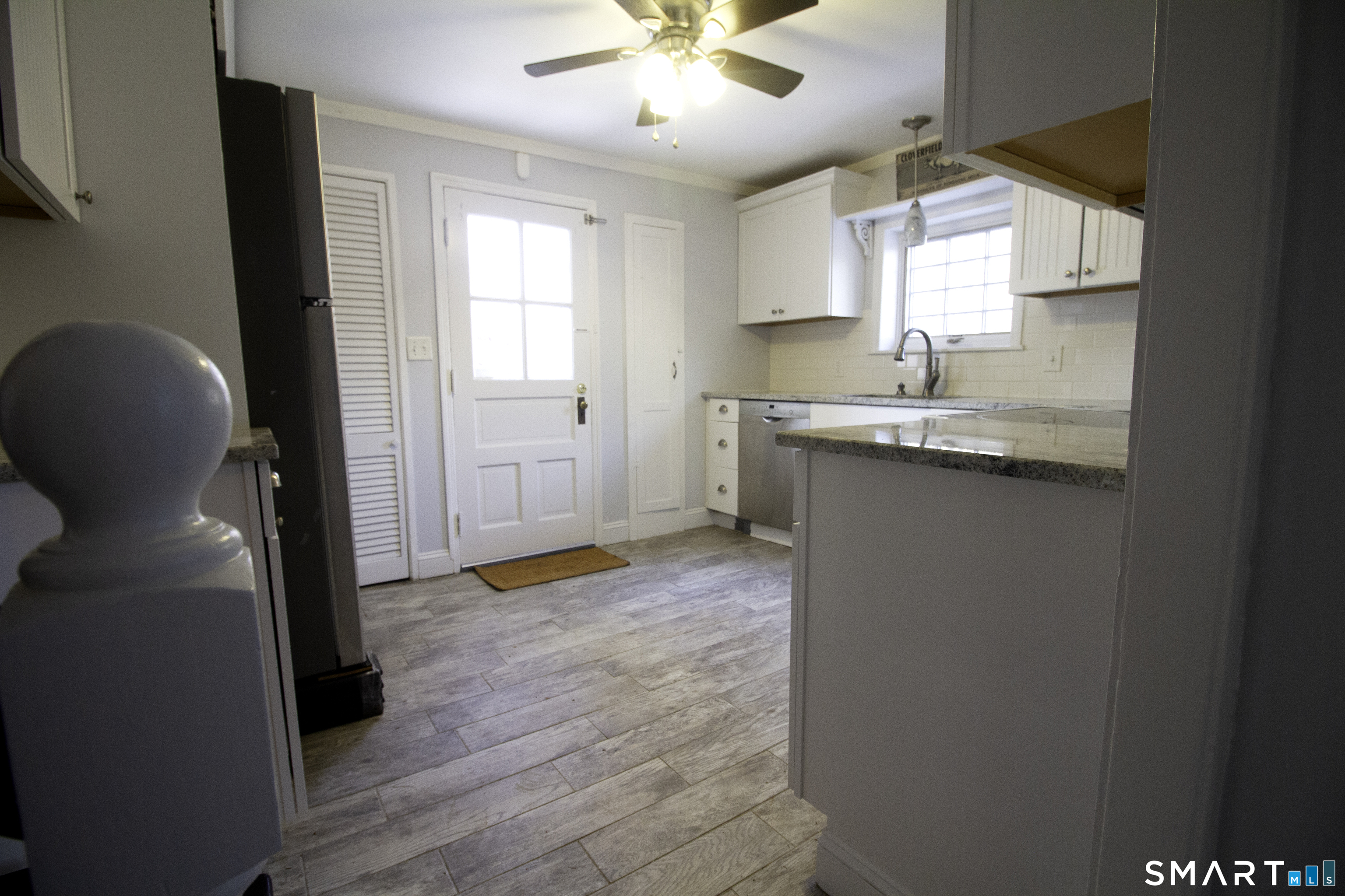 21 B Hoydens Hill Road Fairfield, CT 06824 - Photo 17 of 39 a kitchen with a sink cabinets stainless steel appliances and a window