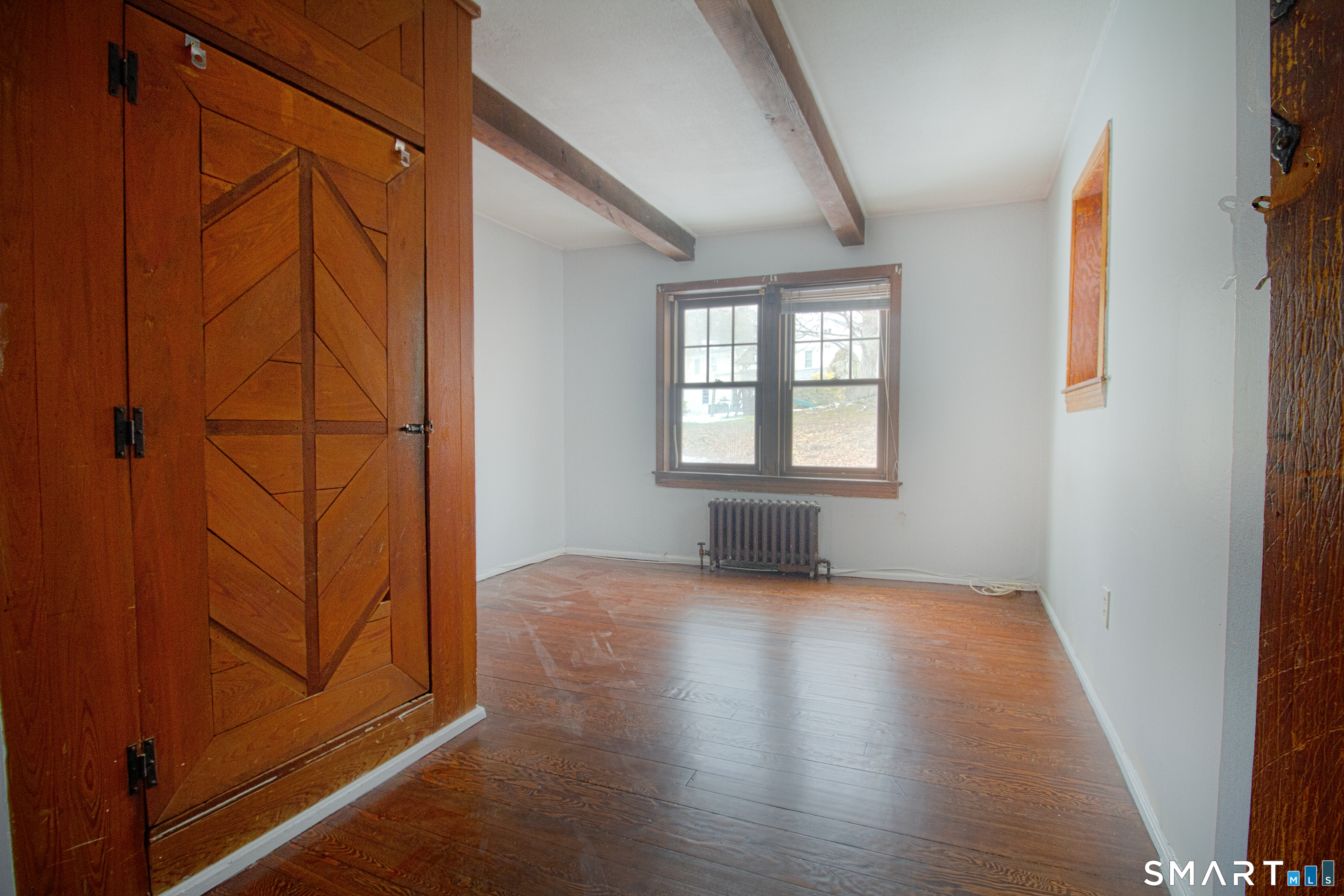 21 B Hoydens Hill Road Fairfield, CT 06824 - Photo 24 of 39 an empty room with wooden floor and windows