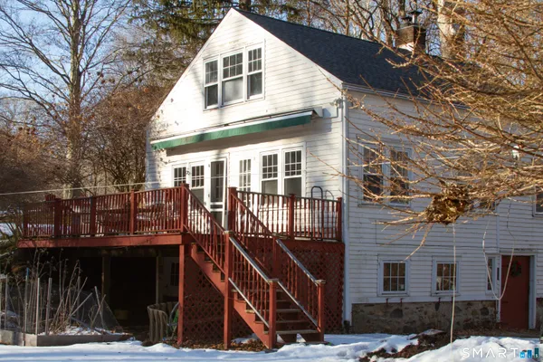 a view of a house with wooden fence