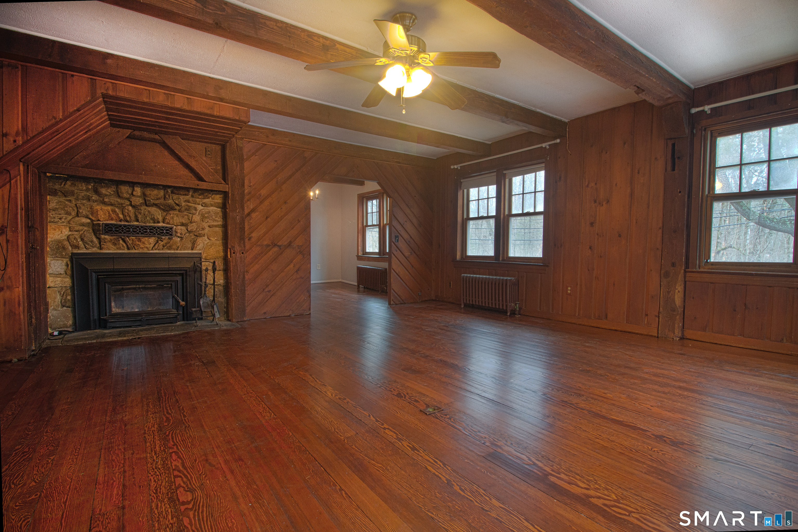 21 B Hoydens Hill Road Fairfield, CT 06824 - Photo 6 of 39 an empty room with wooden floor fireplace and windows