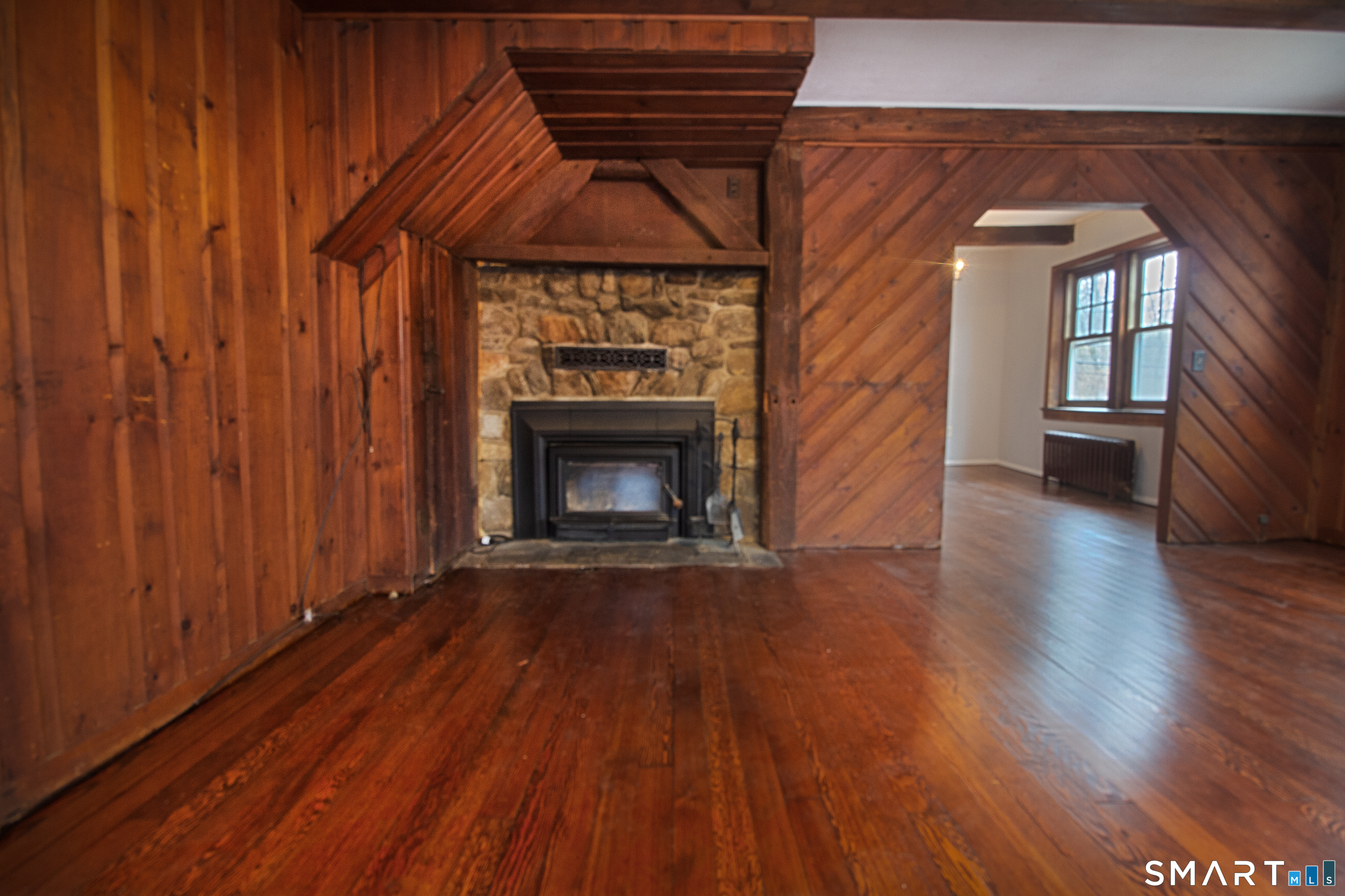 21 B Hoydens Hill Road Fairfield, CT 06824 - Photo 7 of 39 an empty room with wooden floor fireplace and windows
