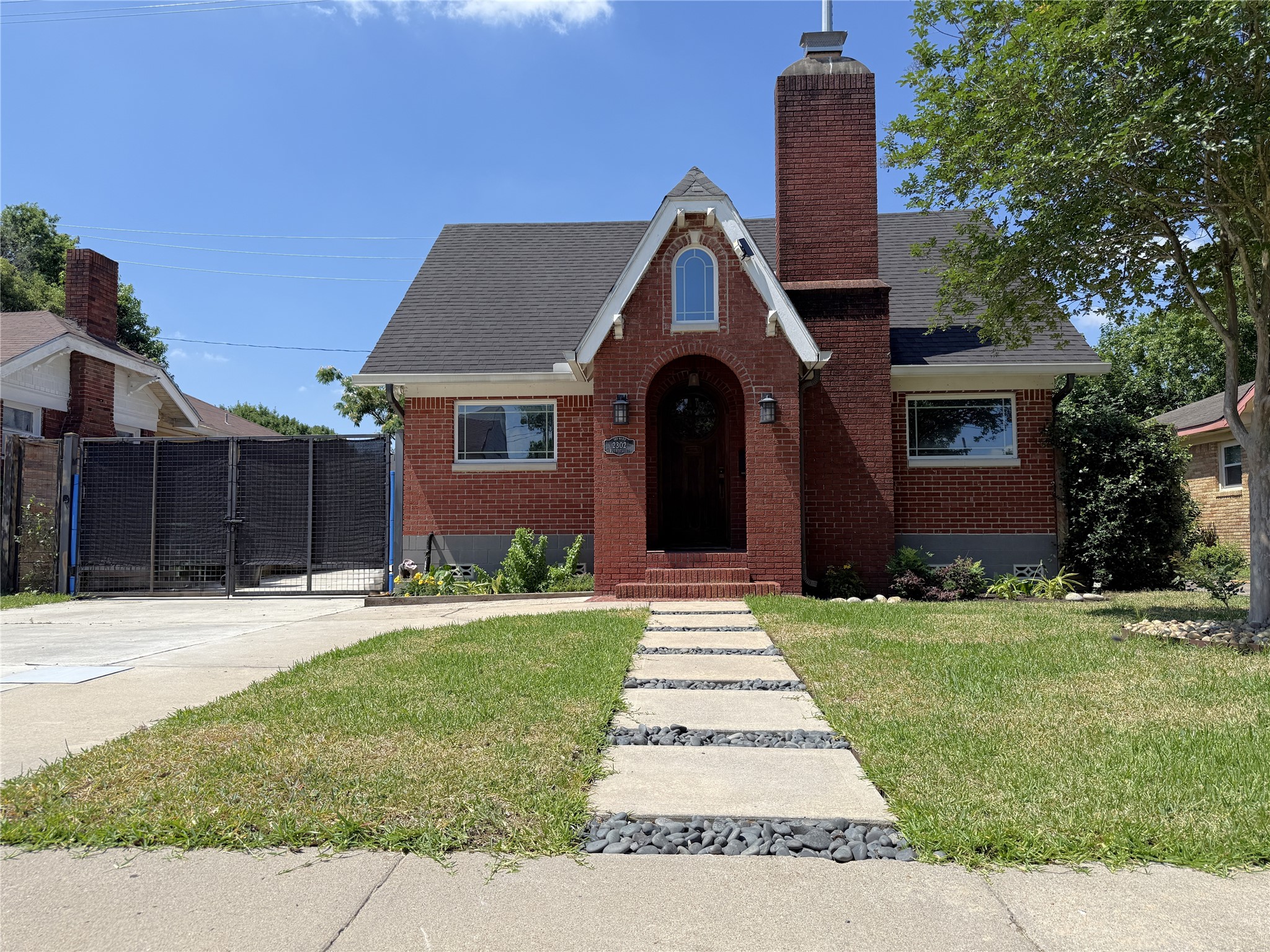 From the neighborhood sidewalk, a paver and rock walkway leads to this charming vintage 1930 home.