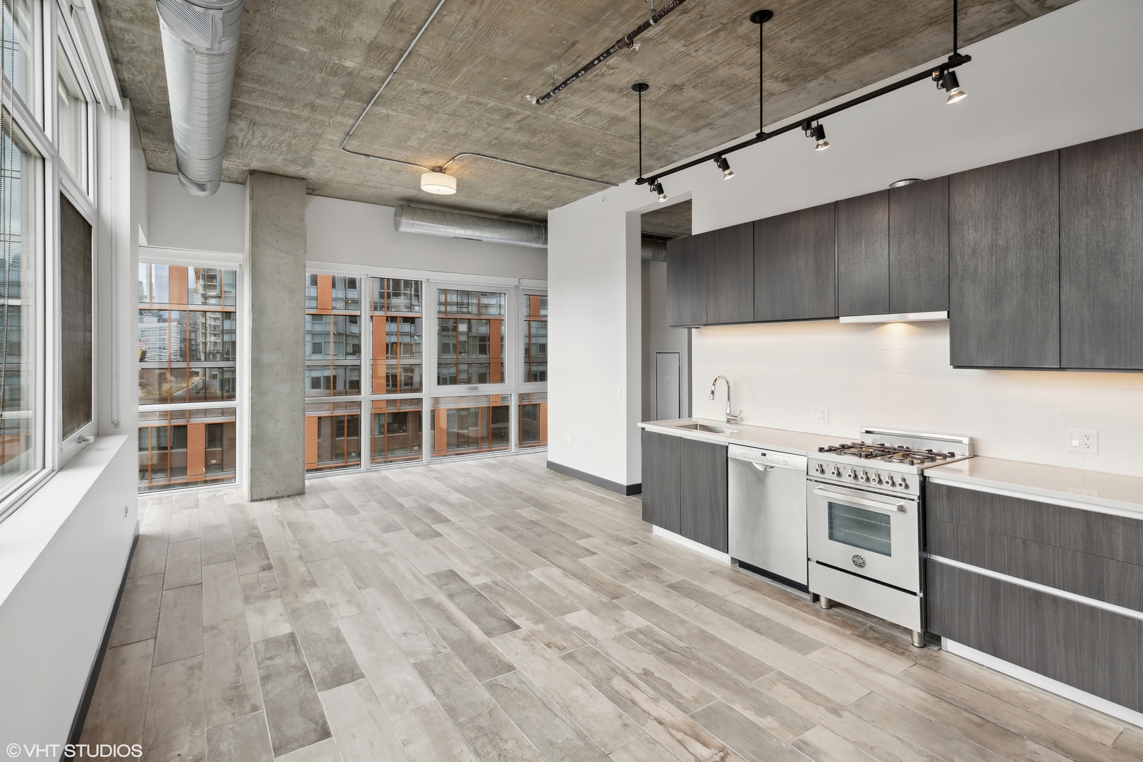 171 North Aberdeen Street, Unit 912 Chicago, IL 60607 - Photo 4 of 21 a kitchen with stainless steel appliances granite countertop a stove and a sink