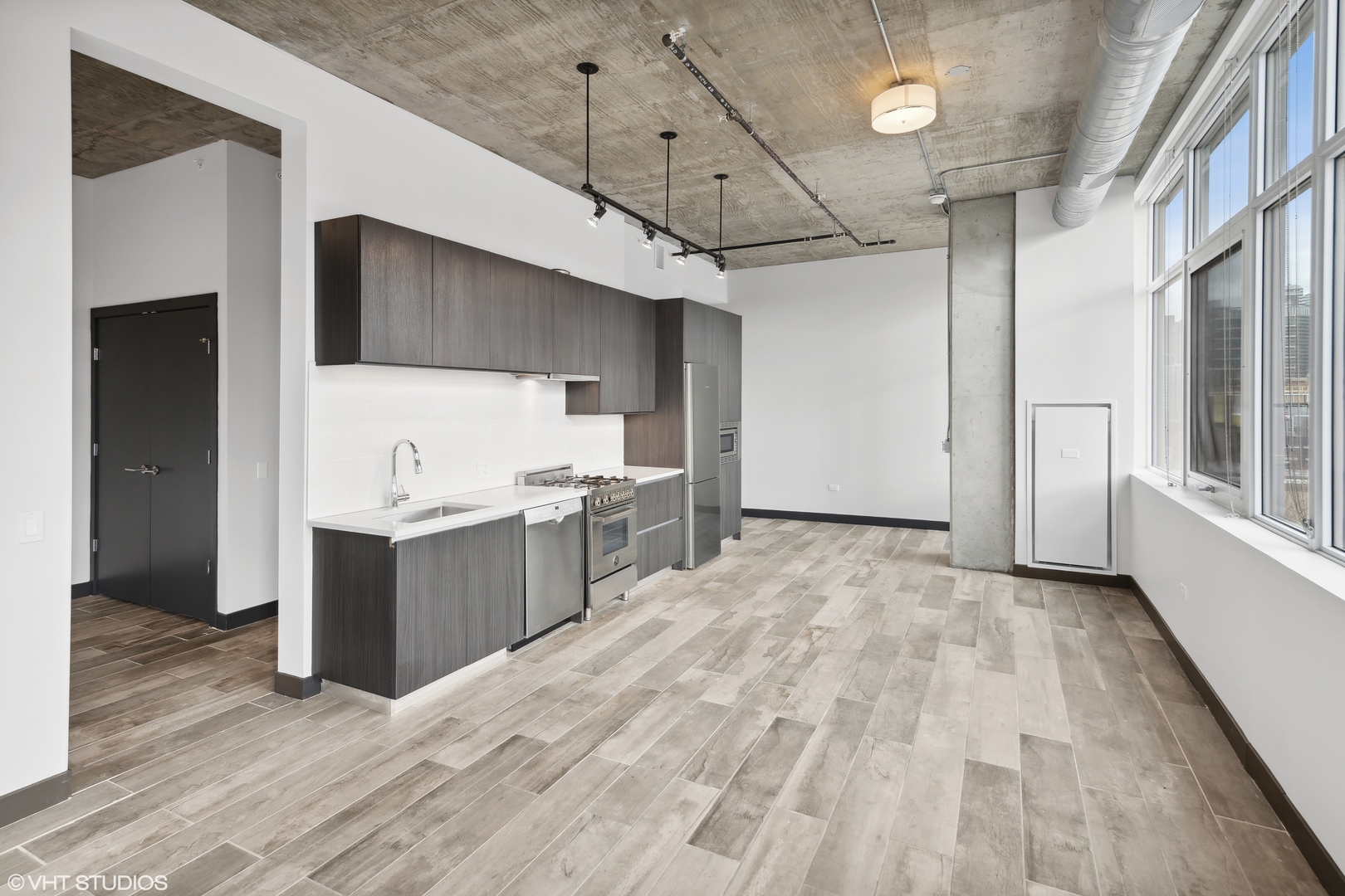 171 North Aberdeen Street, Unit 912 Chicago, IL 60607 - Photo 6 of 21 a view of a kitchen with a sink and wooden floor