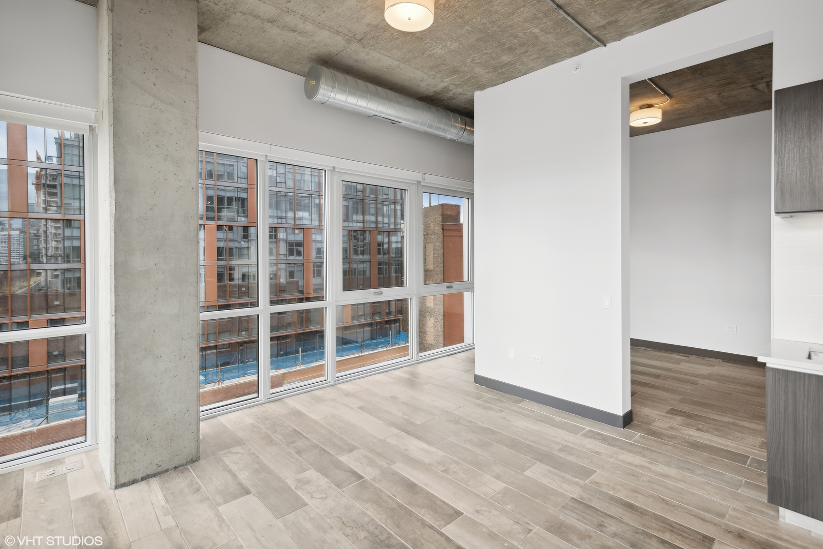 171 North Aberdeen Street, Unit 912 Chicago, IL 60607 - Photo 7 of 21 an empty room with wooden floor and windows