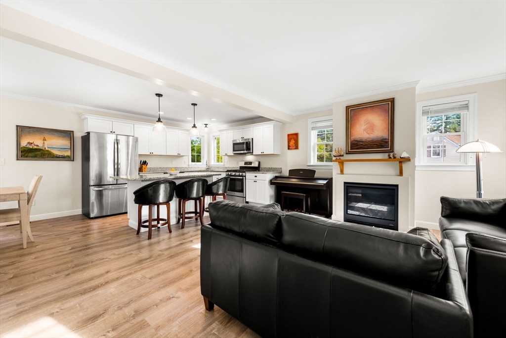 84 Ferry Road Salisbury, MA 01952 - Photo 12 of 42 a living room with furniture a fireplace and a flat screen tv