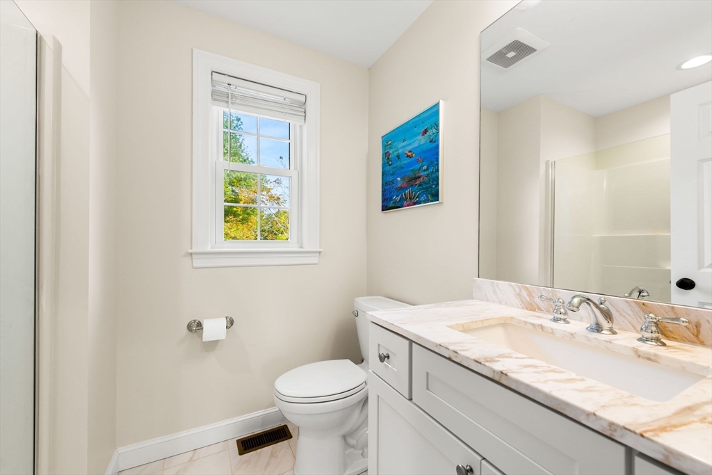 84 Ferry Road Salisbury, MA 01952 - Photo 17 of 42 a bathroom with a granite countertop sink mirror vanity and toilet