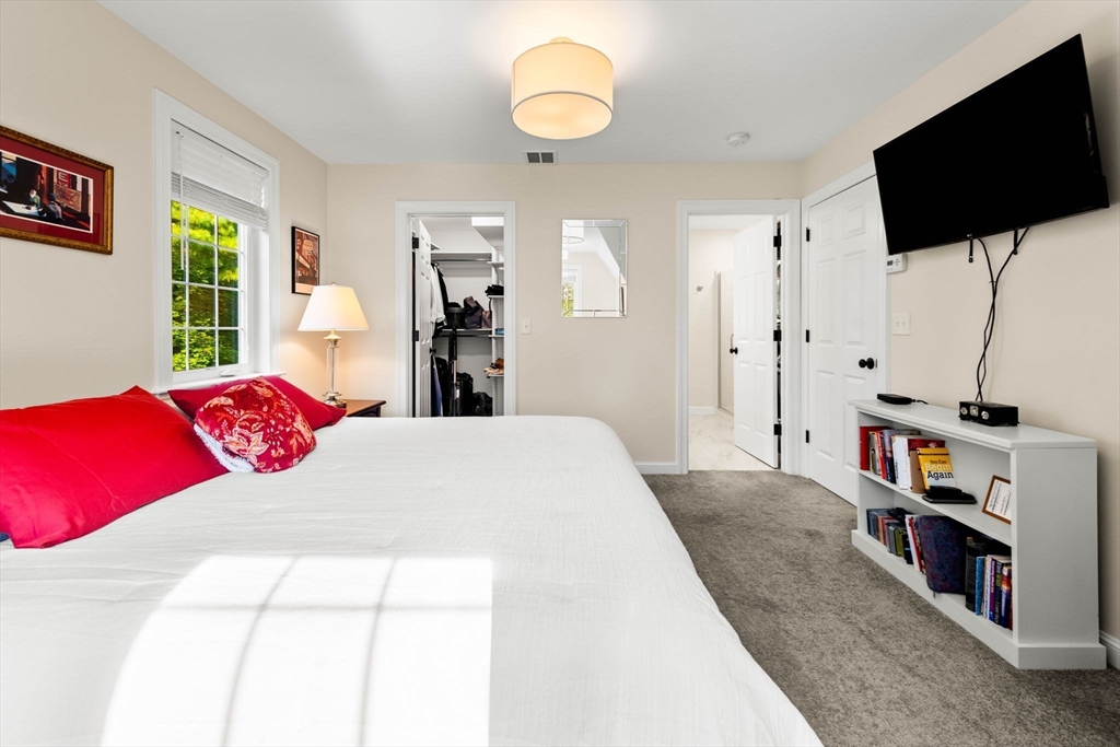 84 Ferry Road Salisbury, MA 01952 - Photo 22 of 42 a bedroom with a bed and a flat screen tv