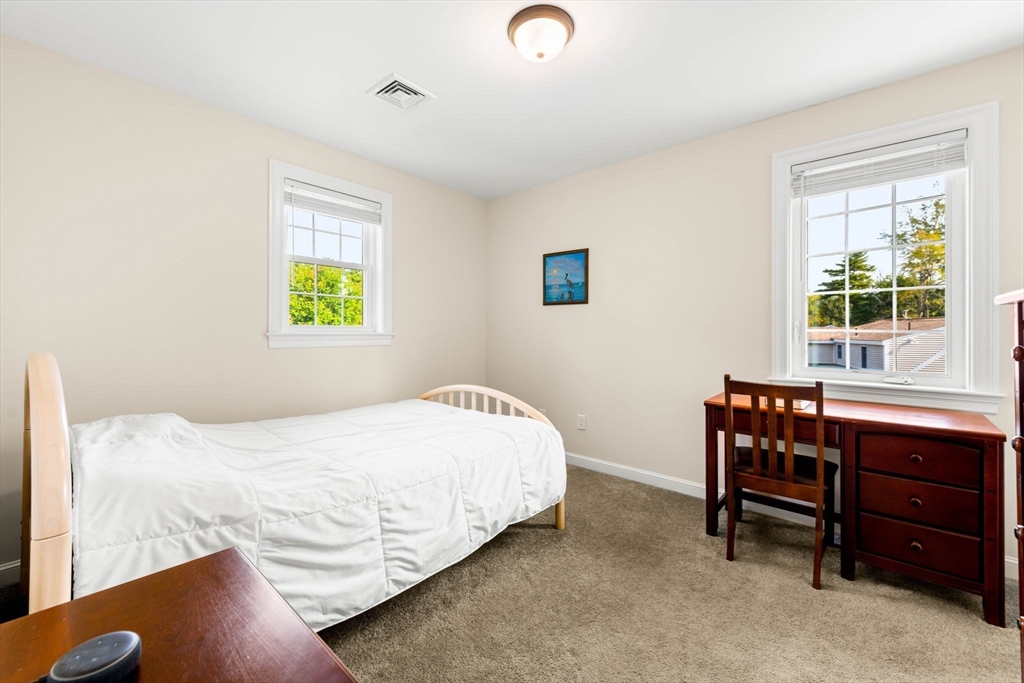 84 Ferry Road Salisbury, MA 01952 - Photo 27 of 42 a bedroom with a bed and a table