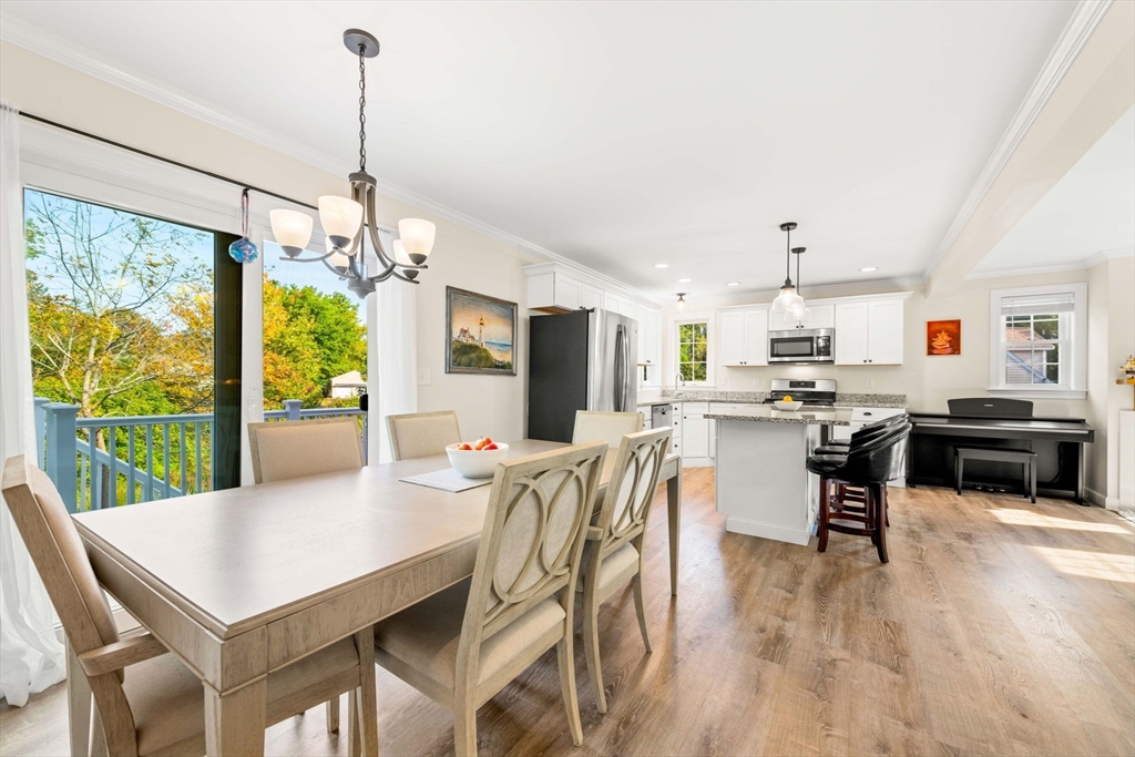 84 Ferry Road Salisbury, MA 01952 - Photo 10 of 42 a view of a dining room and livingroom with furniture wooden floor a chandelier