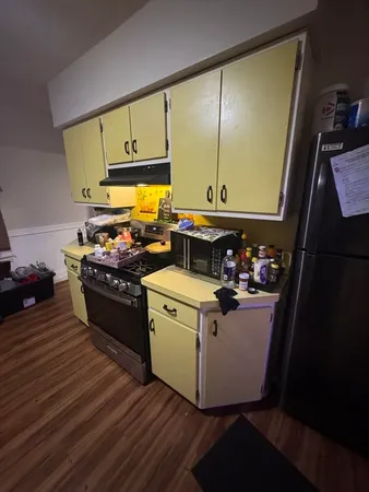 a kitchen with stainless steel appliances a stove a sink and a refrigerator