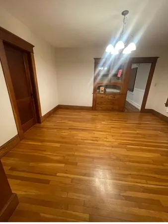 an empty room with wooden floor