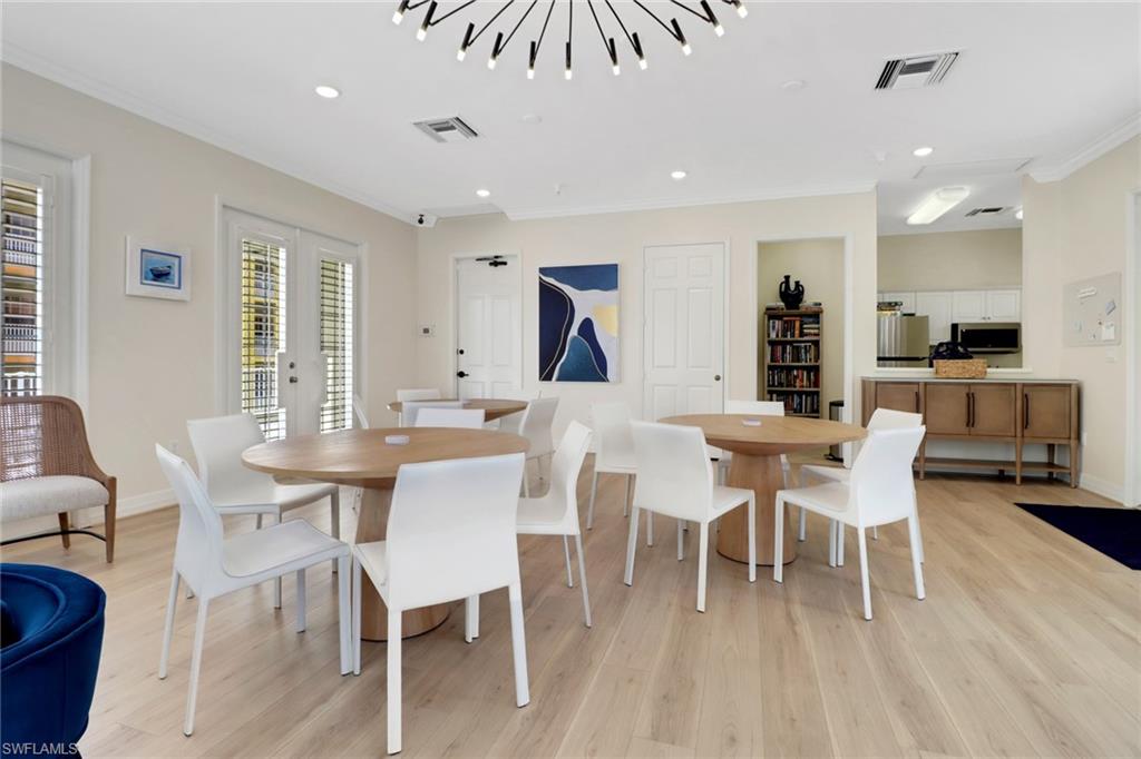 401 Bayfront Place, Unit 3207 Naples, FL 34102 - Photo 19 of 22 Dining space featuring crown molding, light wood-type flooring, recessed lighting, and french doors