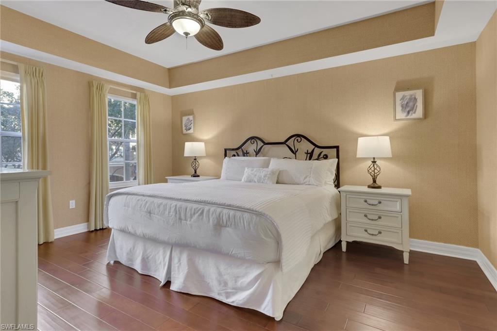 401 Bayfront Place, Unit 3207 Naples, FL 34102 - Photo 3 of 22 Bedroom with a ceiling fan, wood finished floors, and a tray ceiling