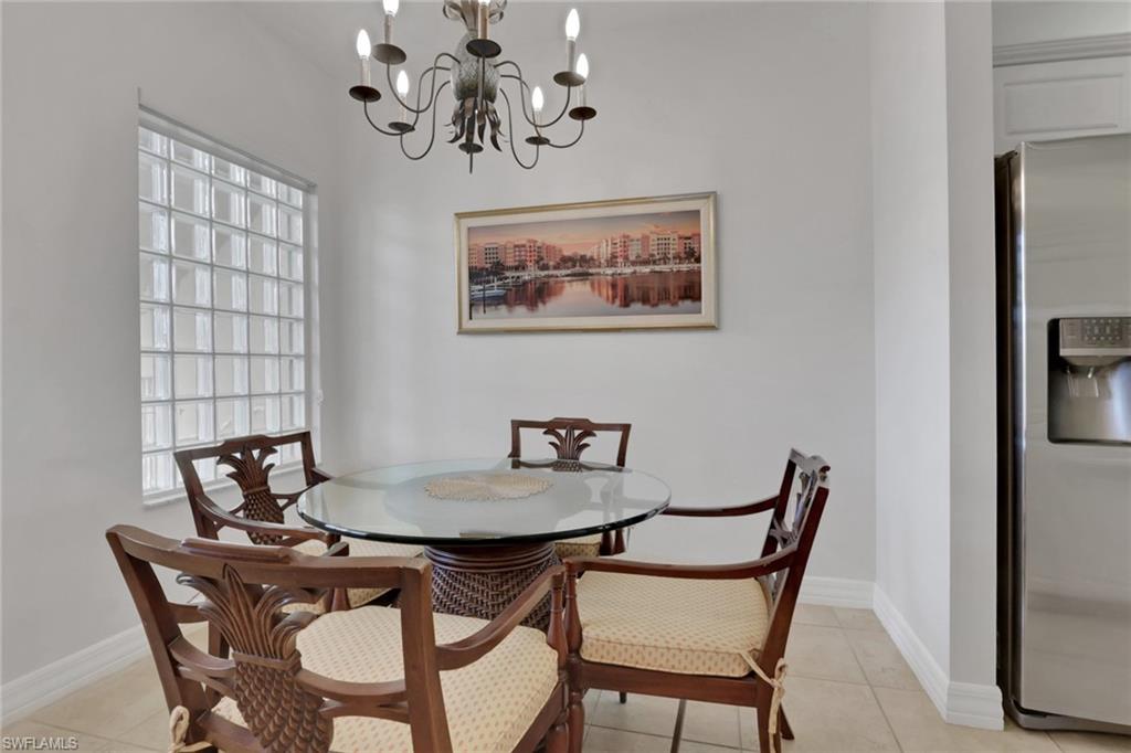 401 Bayfront Place, Unit 3207 Naples, FL 34102 - Photo 8 of 22 Dining room featuring light tile patterned flooring and a chandelier