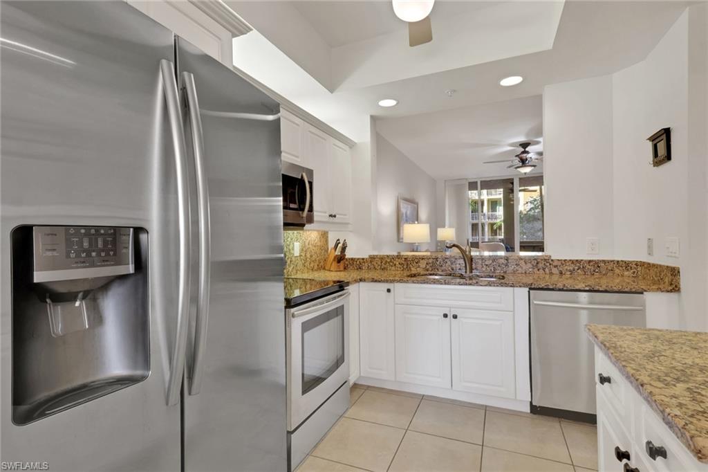 401 Bayfront Place, Unit 3207 Naples, FL 34102 - Photo 10 of 22 Kitchen with stainless steel appliances, recessed lighting, white cabinets, dark stone counters, and light tile patterned flooring
