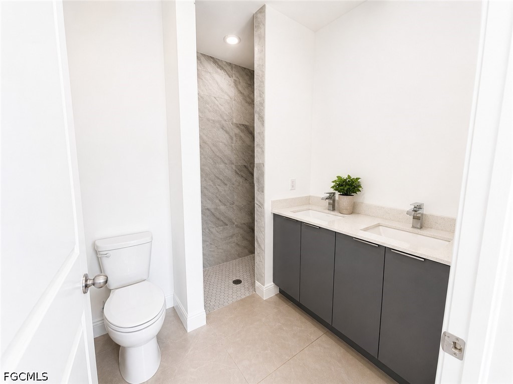 8753 Buckingham Road Lehigh Acres, FL 33971 - Photo 11 of 13 a bathroom with a sink and a toilet