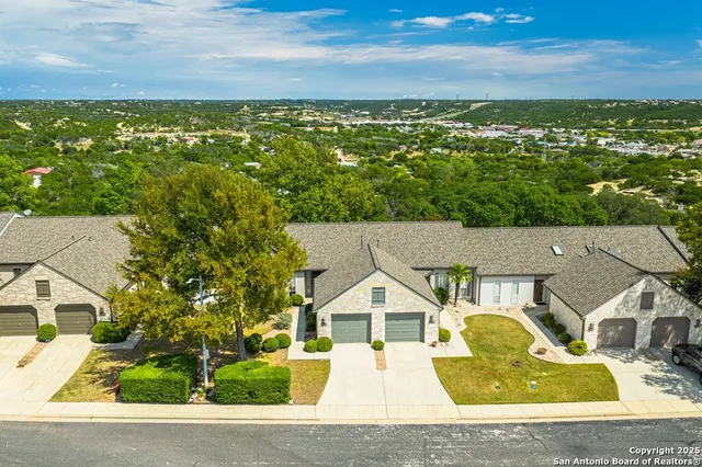 an aerial view of residential houses with outdoor space