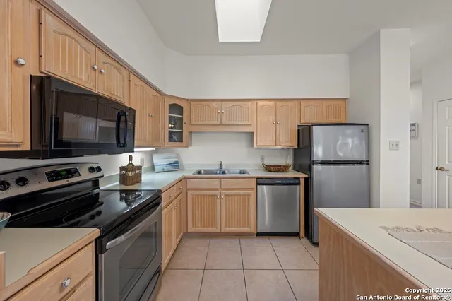 a kitchen with a sink stove and refrigerator