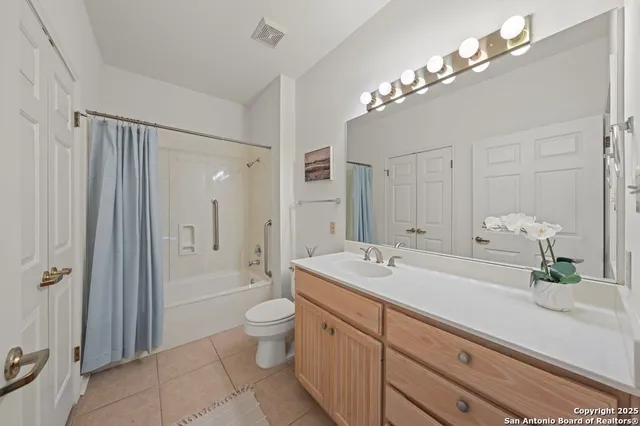 a spacious bathroom with a double vanity sink mirror and shower