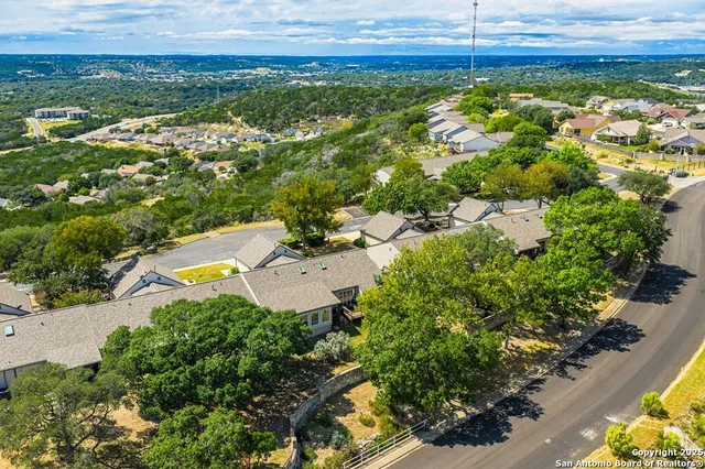 an aerial view of a house with a yard