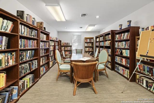 a view of a livingroom with furniture and a bookshelf