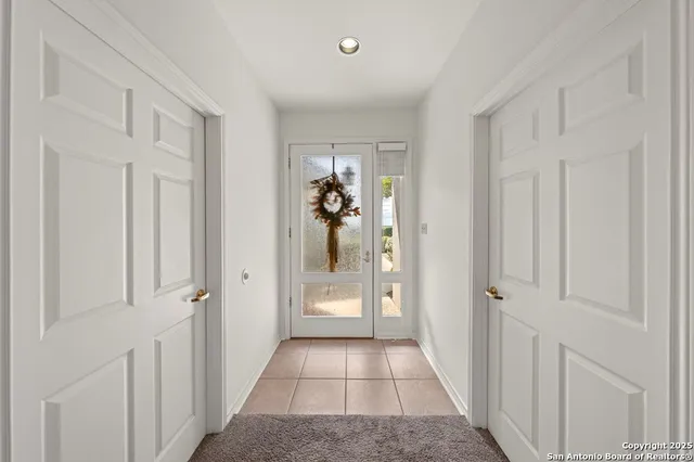 a view of a hallway to rooms