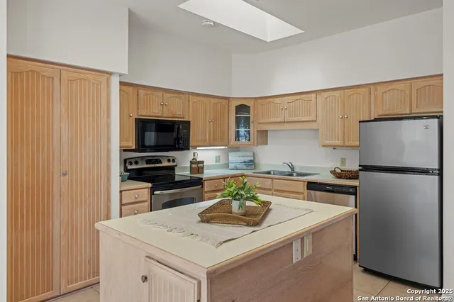 a kitchen with a sink a stove and refrigerator