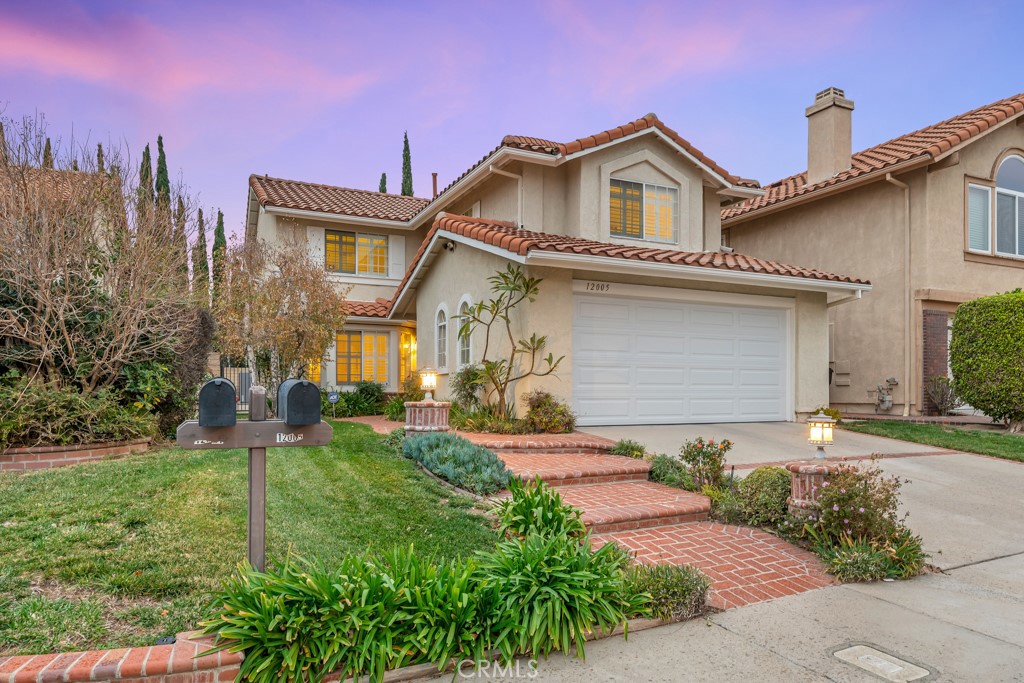 12005 Stone Gate Way Porter Ranch, CA 91326 - Photo 1 of 1 a front view of a house with a yard and garage
