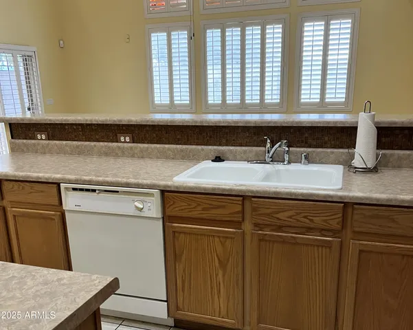 a kitchen with stainless steel appliances kitchen island wooden cabinets a refrigerator and a stove