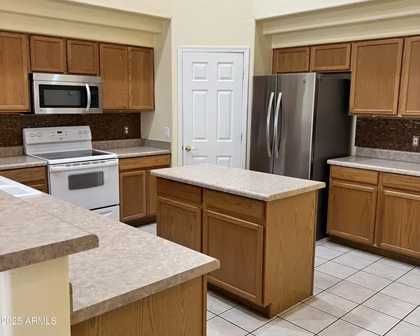 a kitchen with a sink stove and microwave
