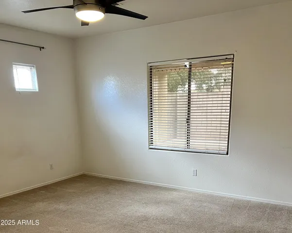 an empty room with a ceiling fan