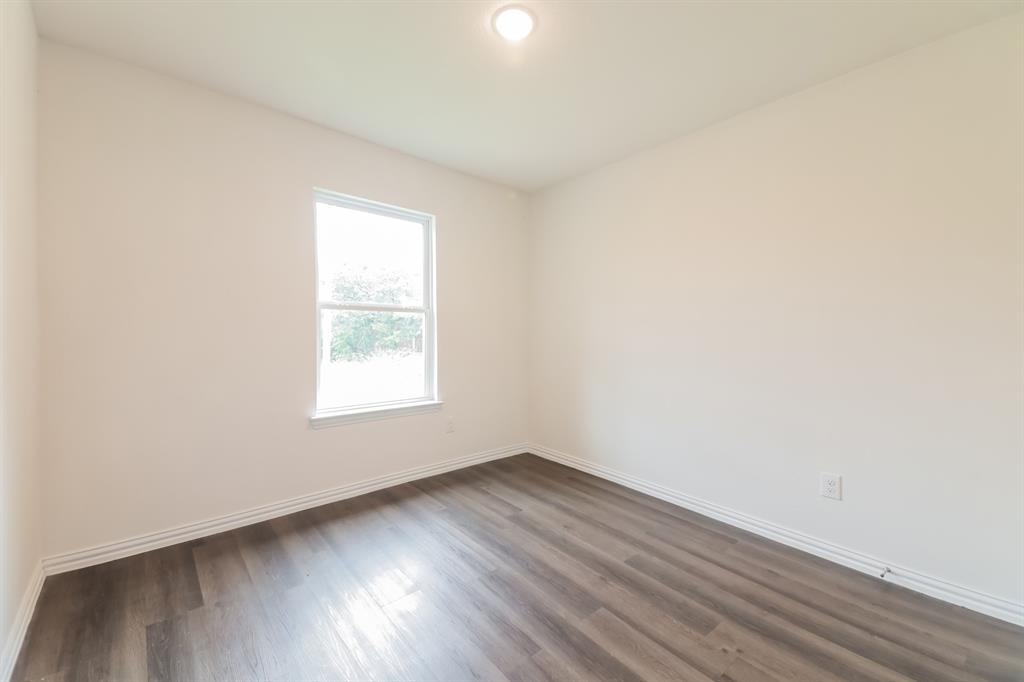 510 East Shepherd Street Denison, TX 75021 - Photo 14 of 21 an empty room with wooden floor and windows